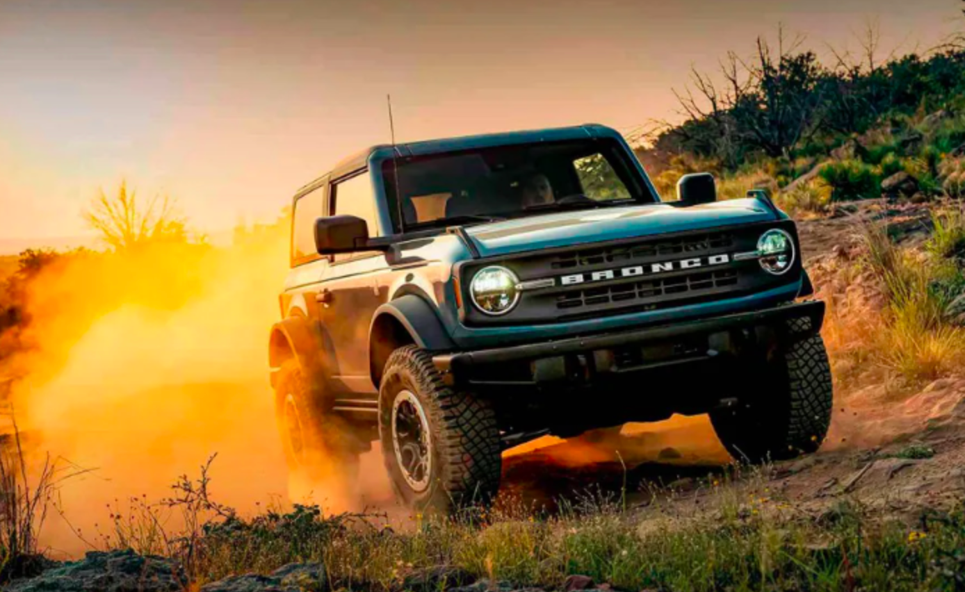 Ford Bronco driving off road and kicking up dust